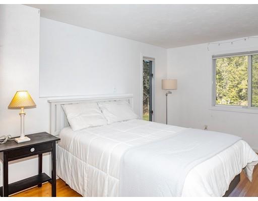 818 Long Pond Road Plymouth, MA 02360 - Photo 27 of 30 a bedroom with a bed and a lamp on table