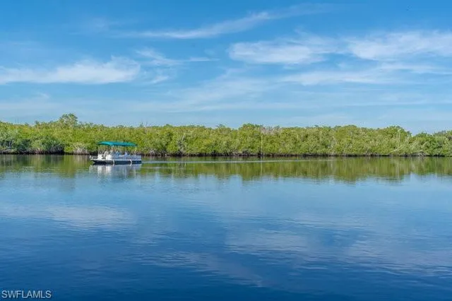 a view of a lake with houses in the back