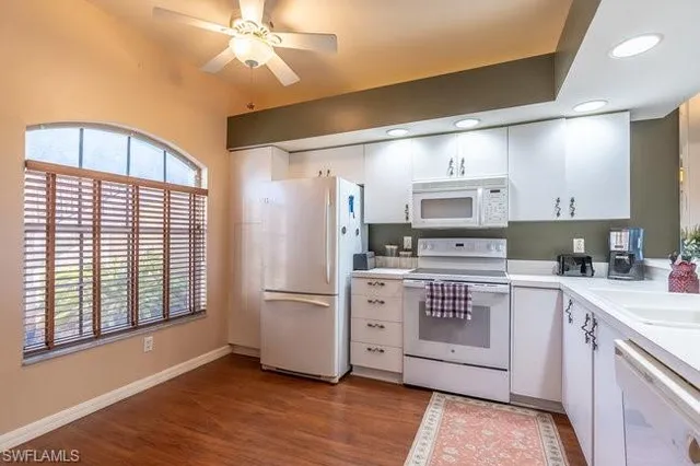 a kitchen with a refrigerator and a stove top oven