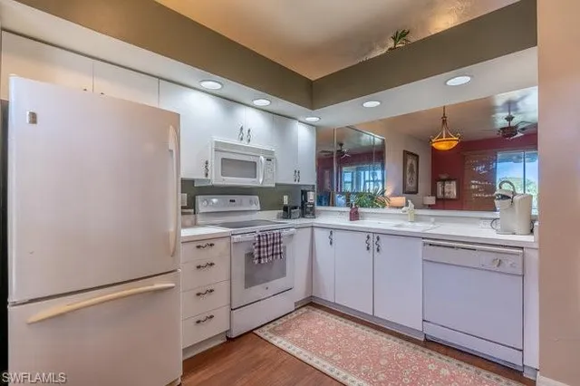 a kitchen with stainless steel appliances granite countertop a sink and cabinets