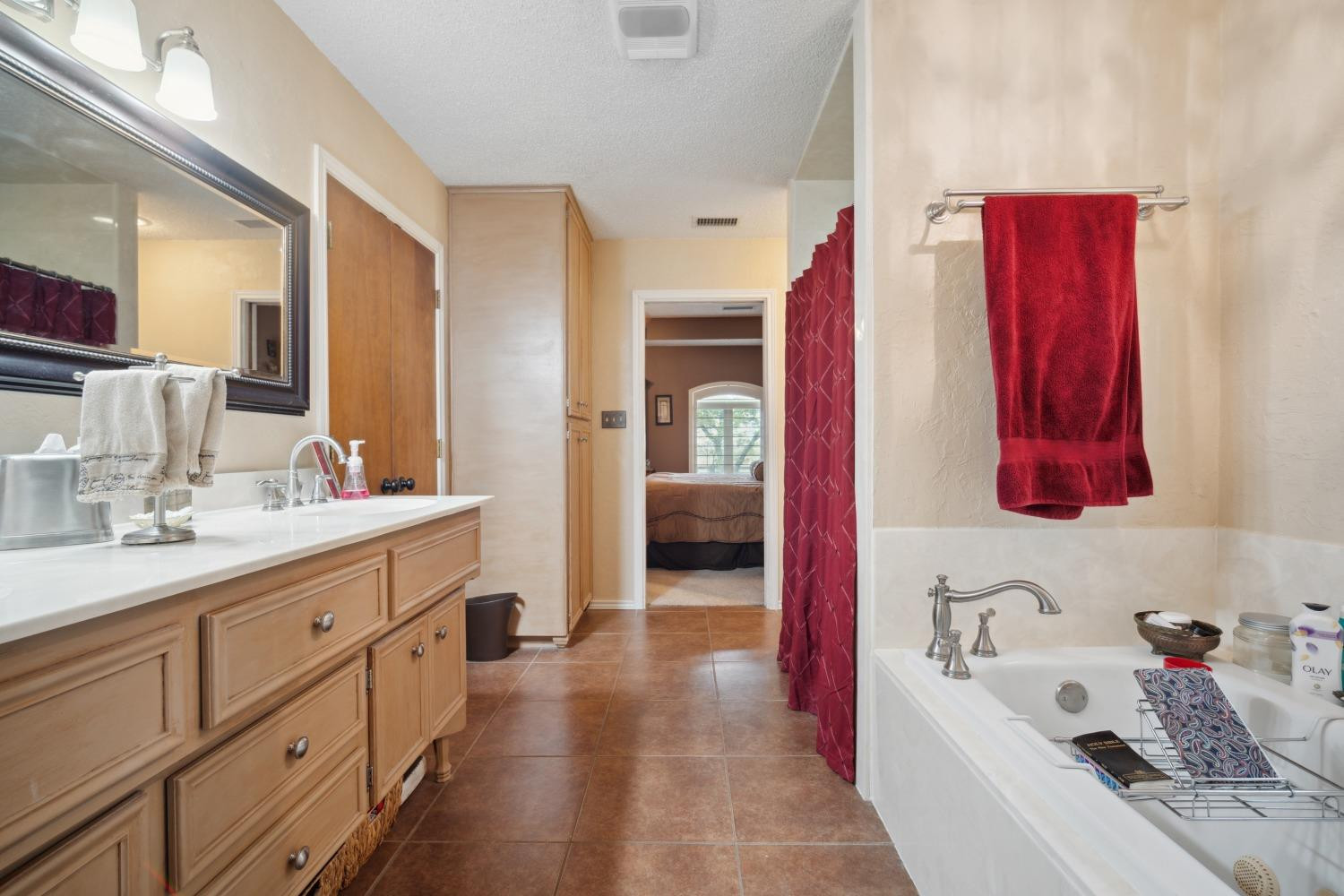 9002 Woodrow Road Wolfforth, TX 79382 - Photo 13 of 48 a en suite bathroom with a sink vanity tub and shower