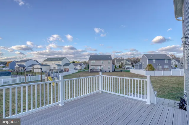 a bedroom with a bed a dresser and a chandelier