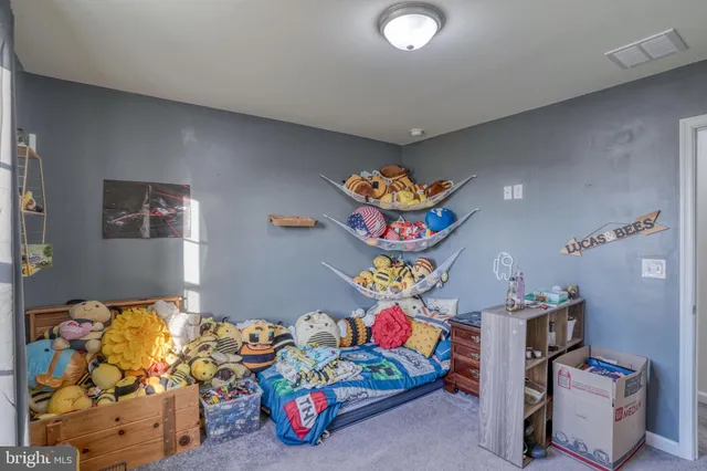 a bedroom with bed and painting on the wall