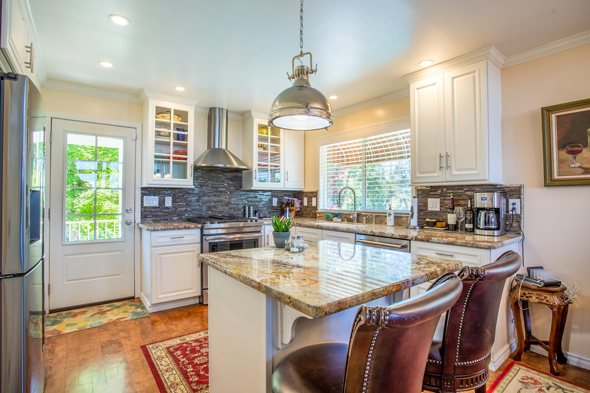 8656 Valley View Road Redding, CA 96001 - Photo 4 of 50 a kitchen with a stove a sink and a refrigerator