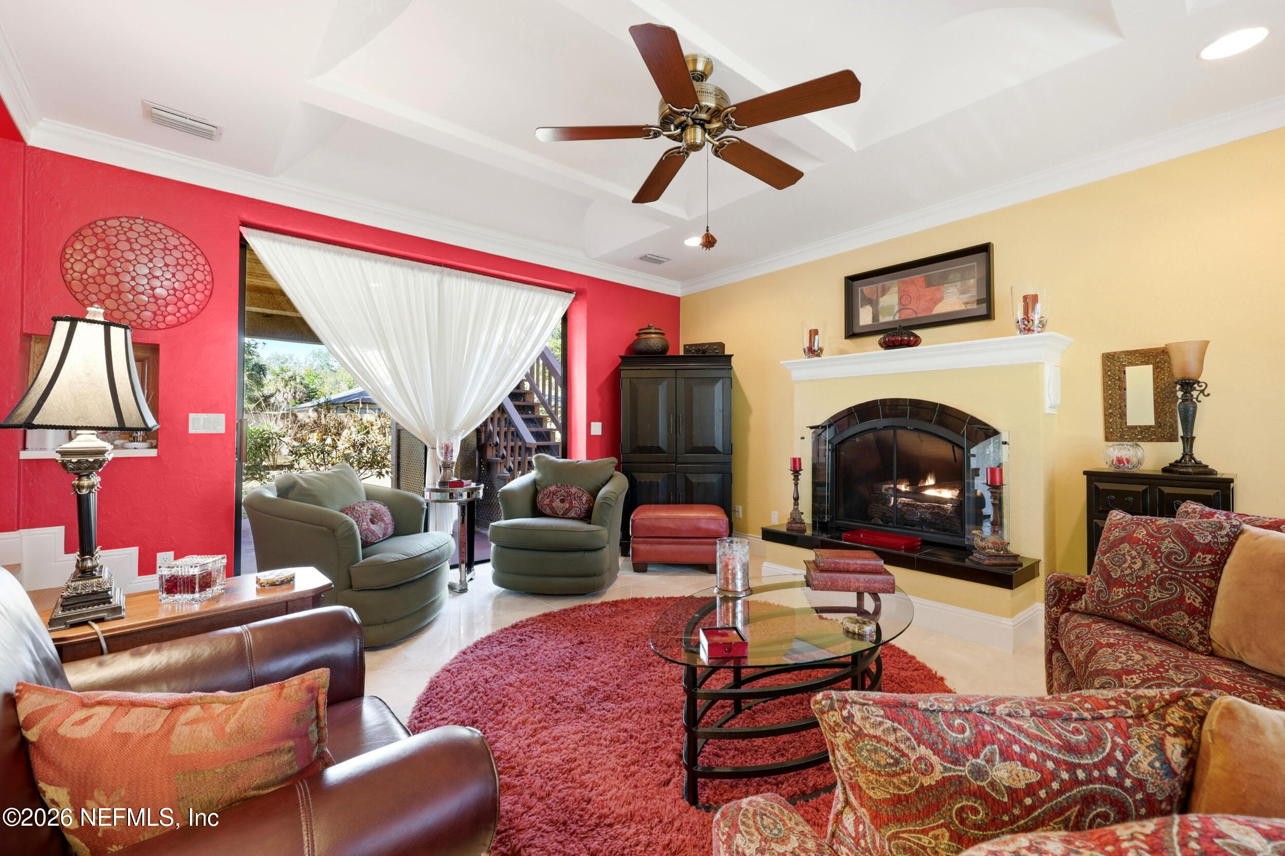 10 Lydia Lane St. Augustine, FL 32080 - Photo 12 of 119 a living room with furniture a fireplace and a flat screen tv