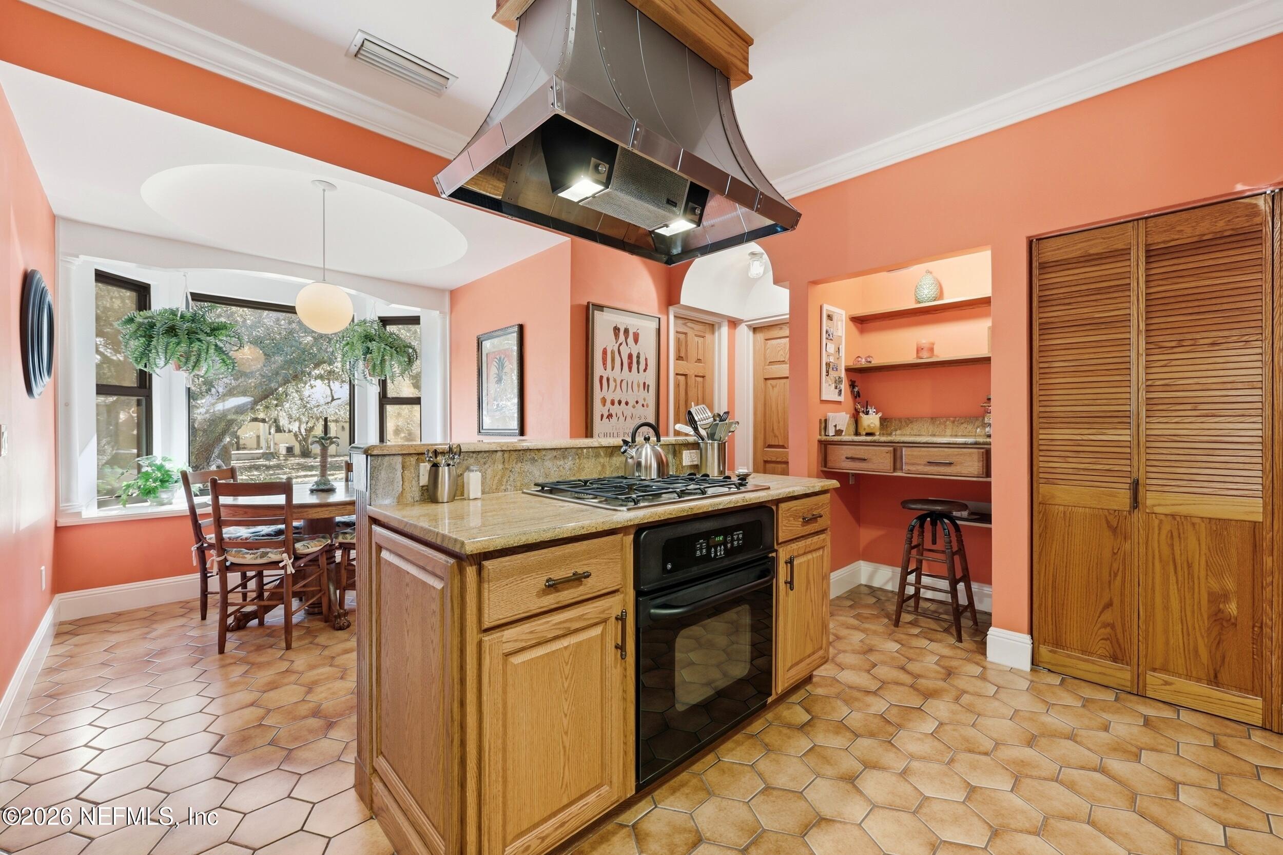 10 Lydia Lane St. Augustine, FL 32080 - Photo 22 of 119 a kitchen with a stove a sink a dining table and chairs with a stove