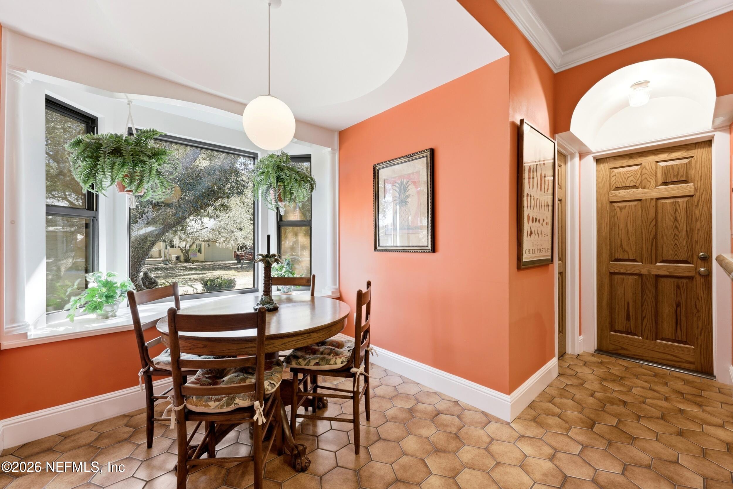 10 Lydia Lane St. Augustine, FL 32080 - Photo 25 of 119 a dining room with furniture a chandelier and window