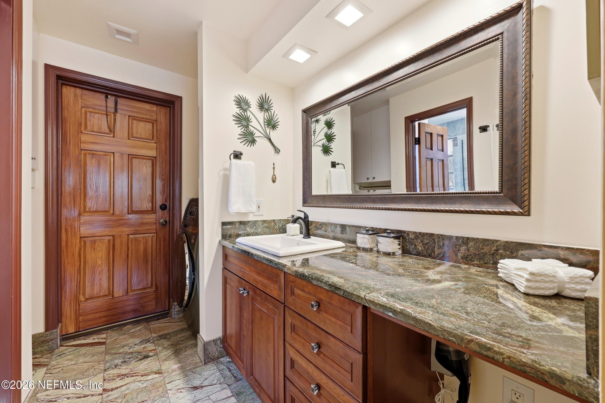 10 Lydia Lane St. Augustine, FL 32080 - Photo 30 of 119 a bathroom with a granite countertop sink and a mirror