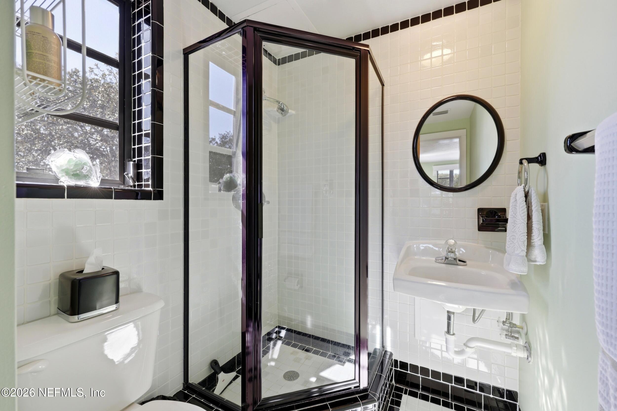 10 Lydia Lane St. Augustine, FL 32080 - Photo 39 of 119 a bathroom with a sink a toilet and a mirror