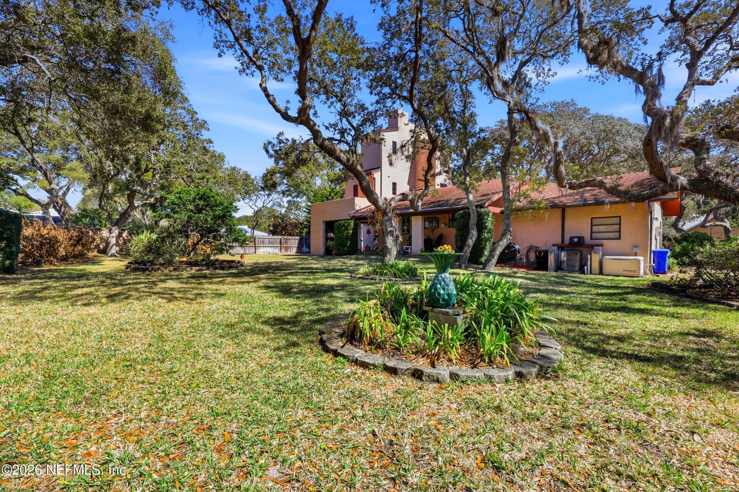 10 Lydia Lane St. Augustine, FL 32080 - Photo 55 of 119 a front view of a house with a yard fountain and a tree