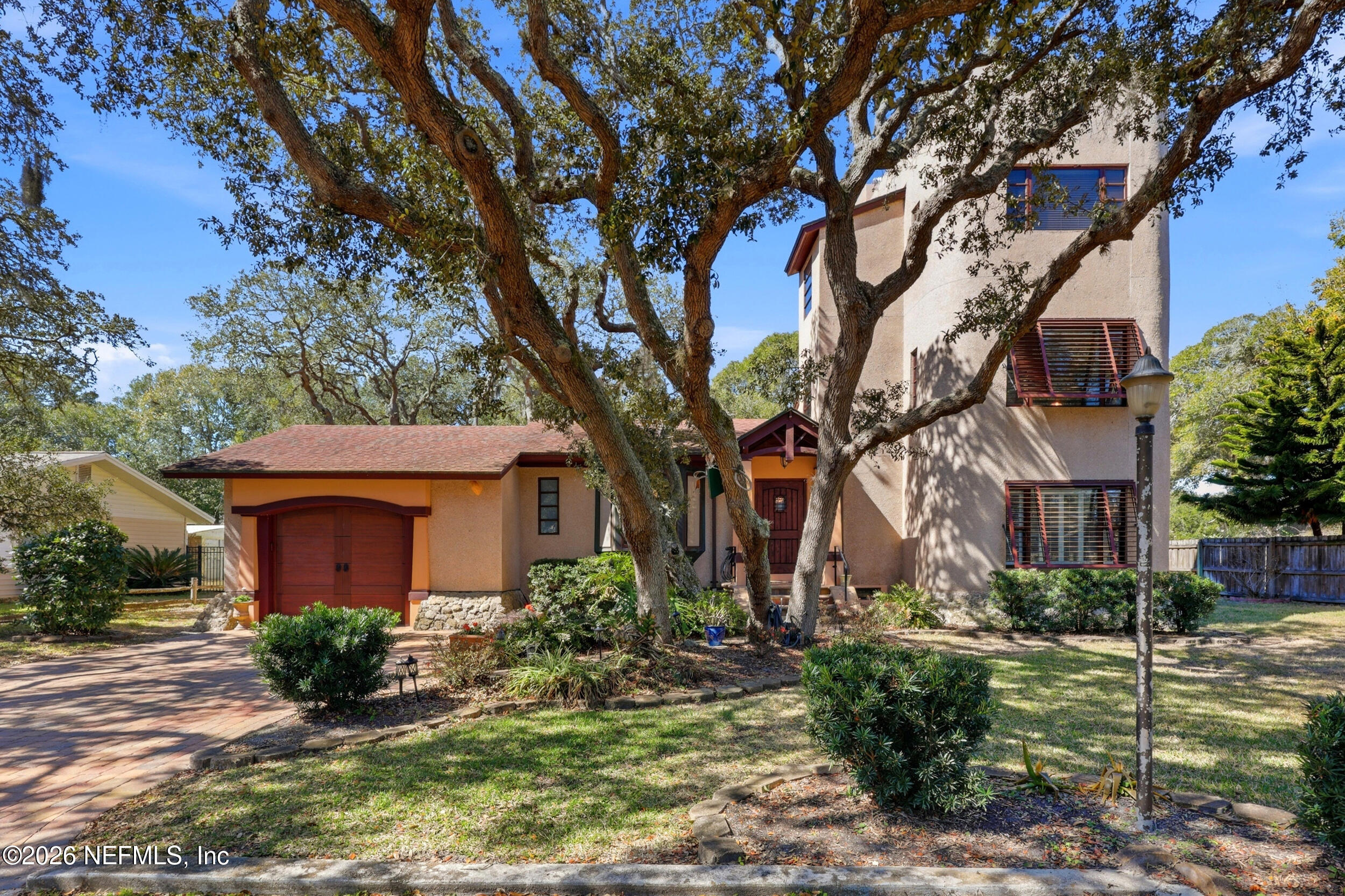 10 Lydia Lane St. Augustine, FL 32080 - Photo 61 of 119 a view of a house with brick walls plants and large tree