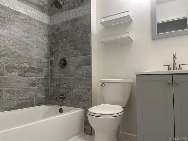 a bathroom with a white bath tub a toilet and a sink