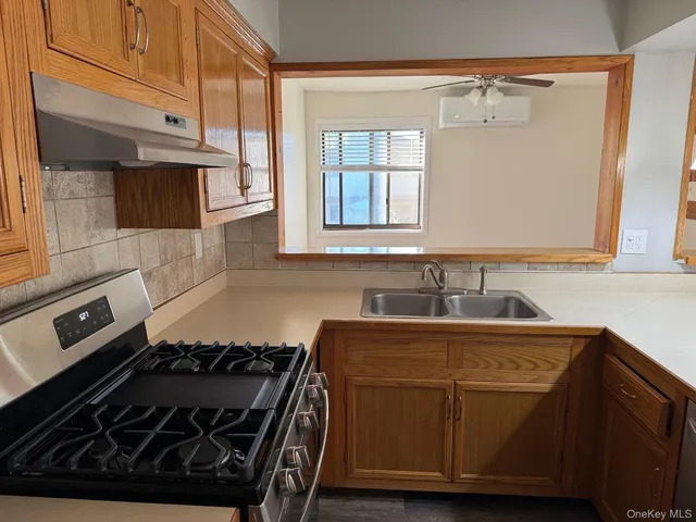 a kitchen with granite countertop a stove and a sink