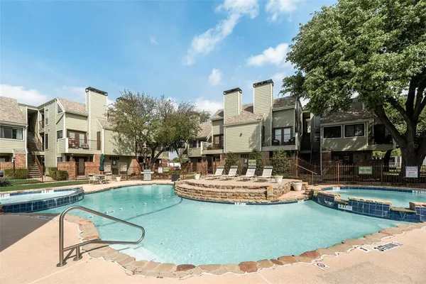 a view of a house with swimming pool and sitting area