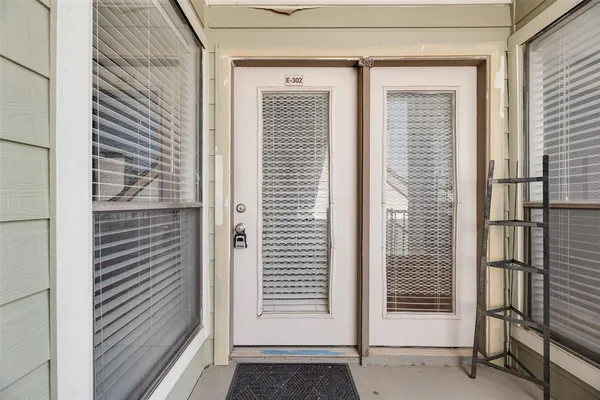 a view of a door and a window