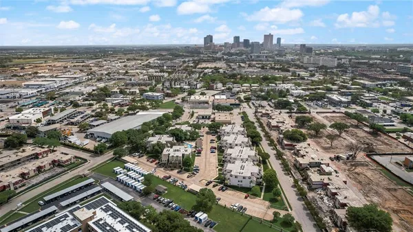 an aerial view of residential building with green space