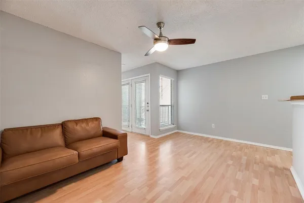 a living room with furniture and a ceiling fan