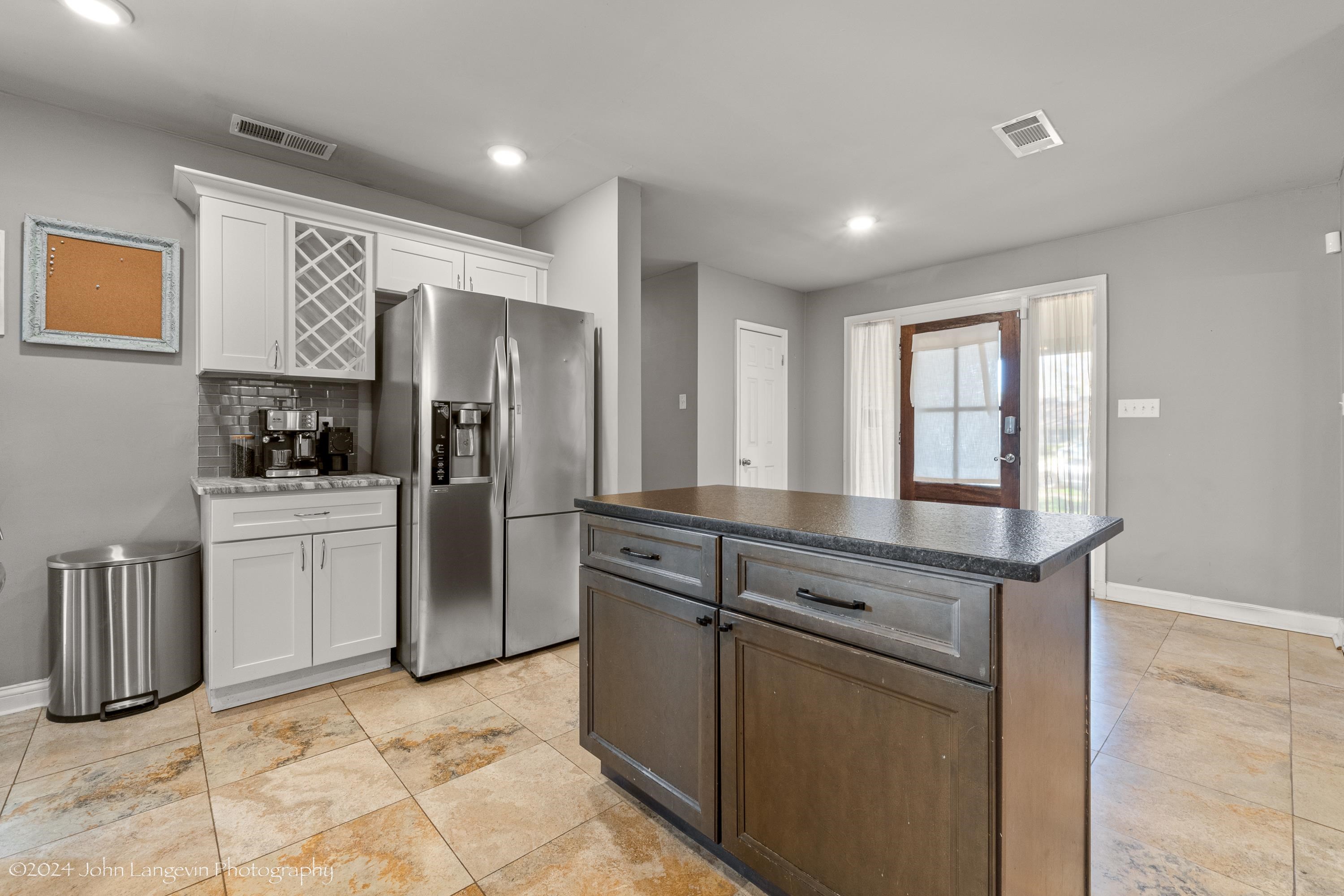 3381 Walnut Grove Road Memphis, TN 38111 - Photo 21 of 25 a kitchen with refrigerator cabinets and furniture