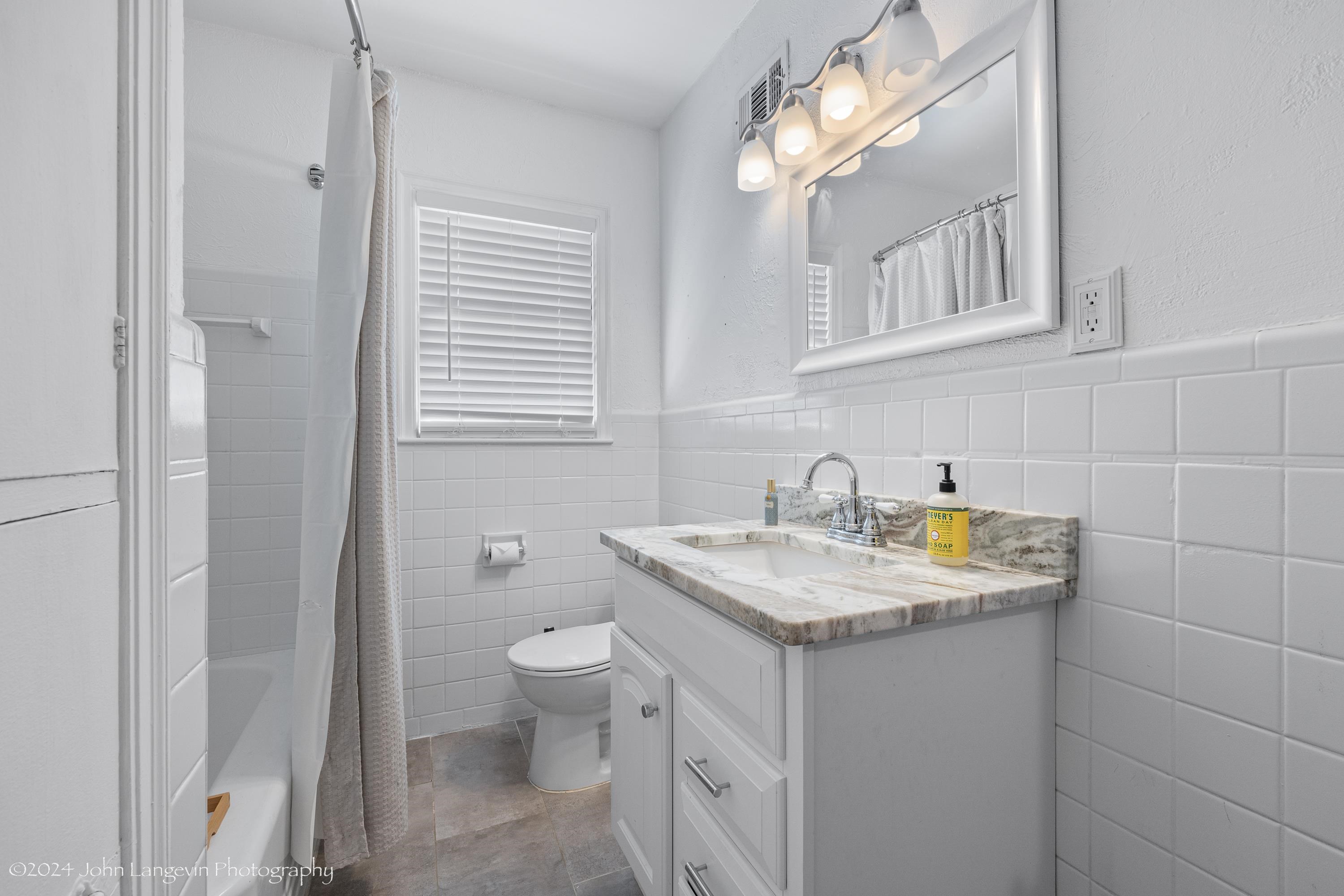 3381 Walnut Grove Road Memphis, TN 38111 - Photo 5 of 25 a bathroom with a granite countertop sink and a toilet