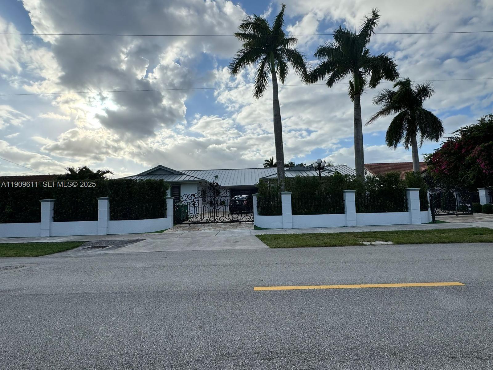 a front view of multiple houses with palm trees