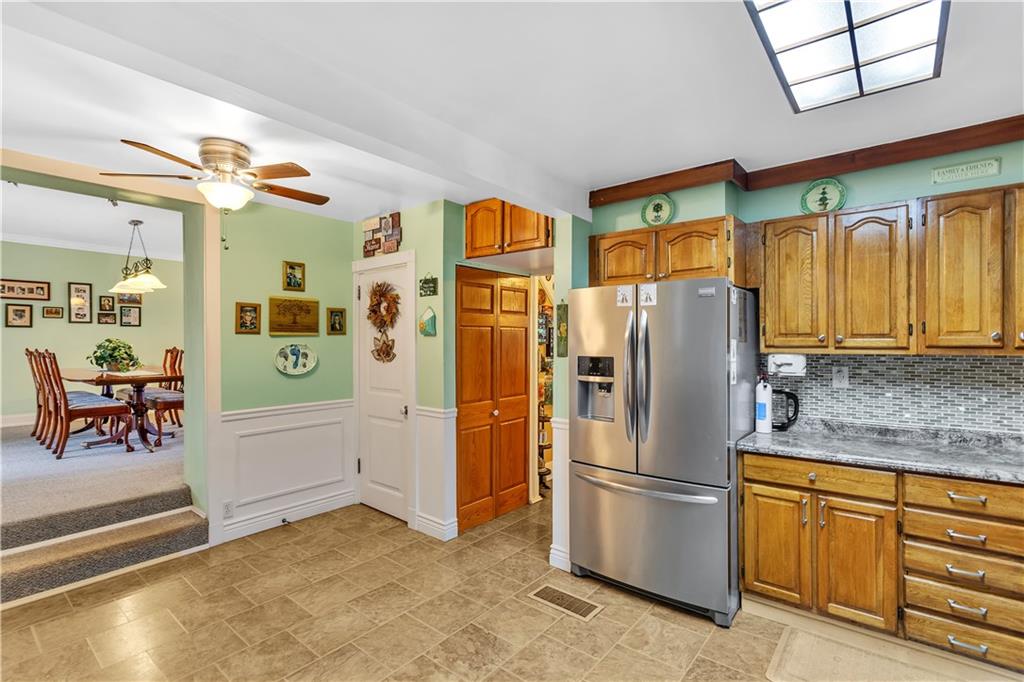 213 Whittier Street Vandergrift, PA 15690 - Photo 12 of 37 a kitchen with stainless steel appliances granite countertop a refrigerator and a sink