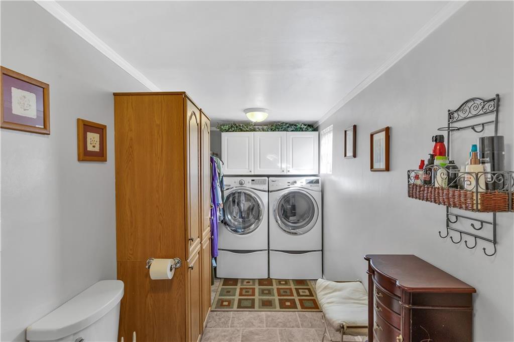213 Whittier Street Vandergrift, PA 15690 - Photo 20 of 37 a utility room with dryer washer and a view of living room
