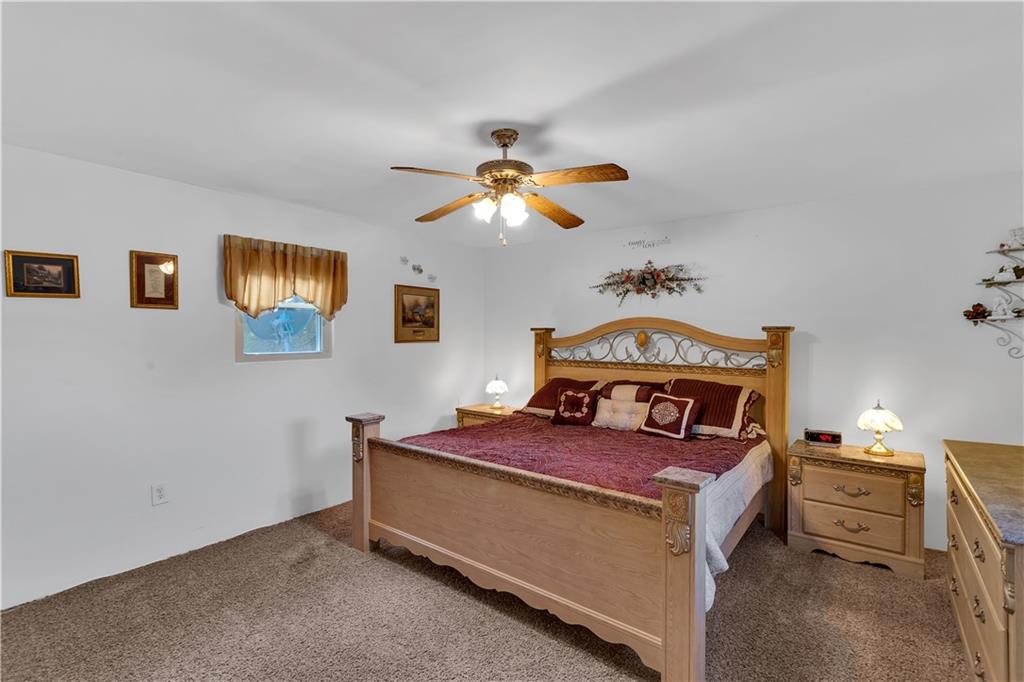 213 Whittier Street Vandergrift, PA 15690 - Photo 25 of 37 a bedroom with a bed and a chandelier