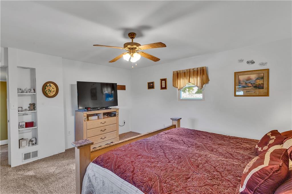 213 Whittier Street Vandergrift, PA 15690 - Photo 26 of 37 a bedroom with a bed and a flat screen tv