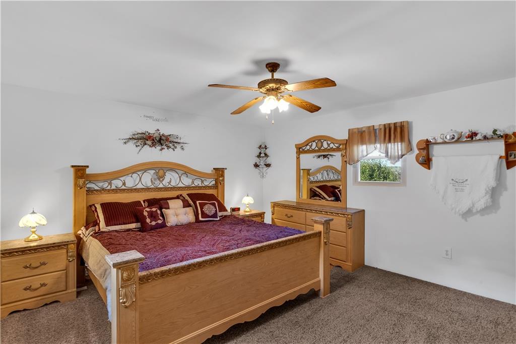 213 Whittier Street Vandergrift, PA 15690 - Photo 27 of 37 a room with a bed and a chandelier