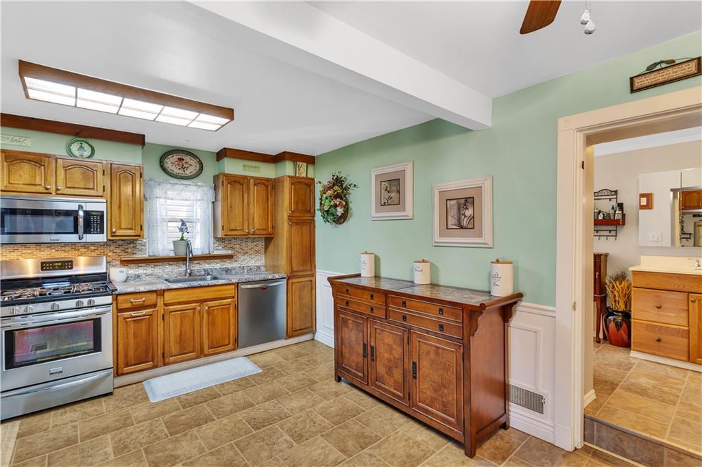 213 Whittier Street Vandergrift, PA 15690 - Photo 10 of 37 a kitchen with stainless steel appliances granite countertop a stove and a sink