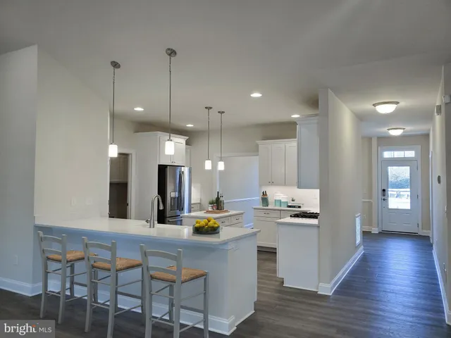 a kitchen with kitchen island appliances and wooden floor