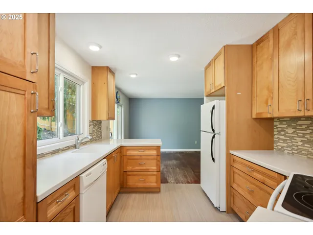a kitchen with stainless steel appliances granite countertop a refrigerator and a sink