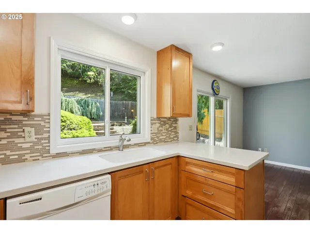 a kitchen with a sink and large window