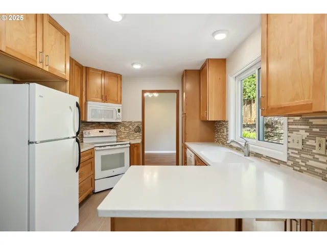 a kitchen with stainless steel appliances a refrigerator sink and cabinets