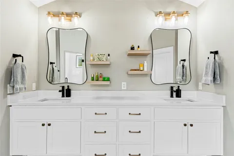 a bathroom with sink vanity and a mirror