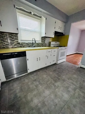 a view of kitchen with granite countertop window and sink