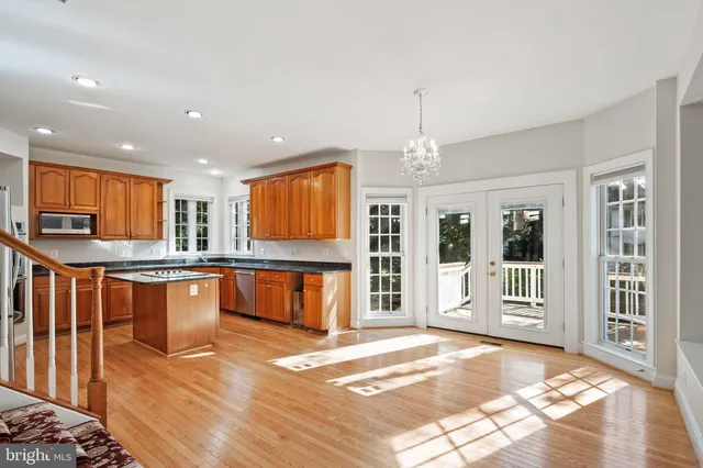 a view of an empty room with window and fire place