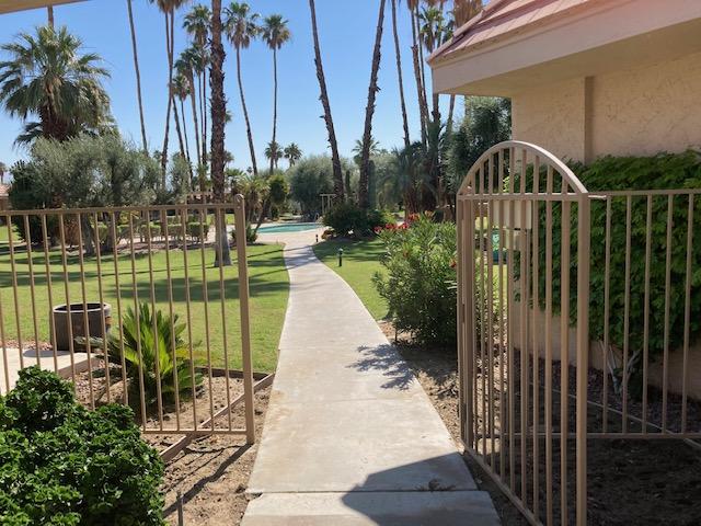 45760 Pima Road Indian Wells, CA 92210 - Photo 23 of 28 a view of a swimming pool with a patio and a fountain