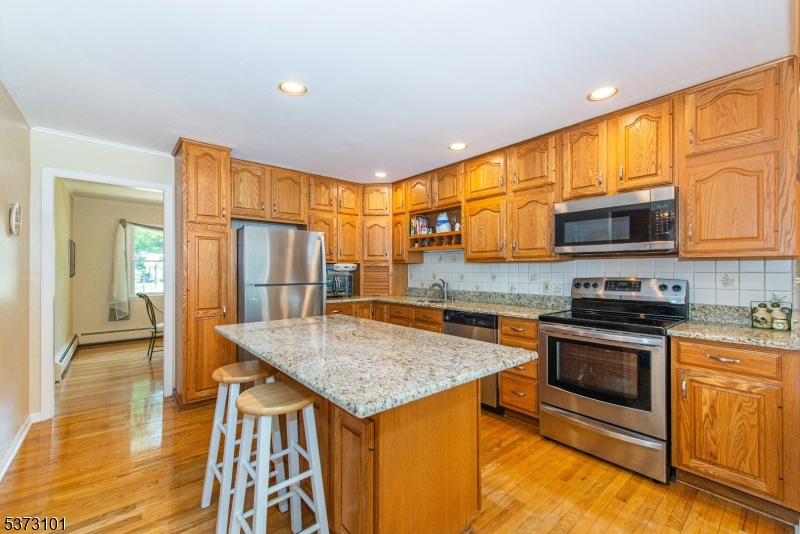 10 Campo Road Randolph, NJ 07869 - Photo 15 of 49 a kitchen with stainless steel appliances granite countertop a stove top oven a sink and a microwave