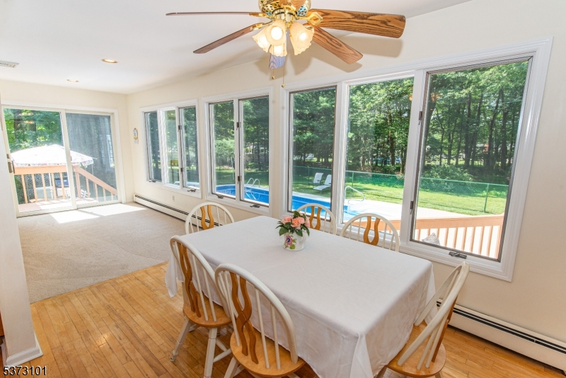 10 Campo Road Randolph, NJ 07869 - Photo 18 of 49 a dining room with furniture a chandelier and large windows
