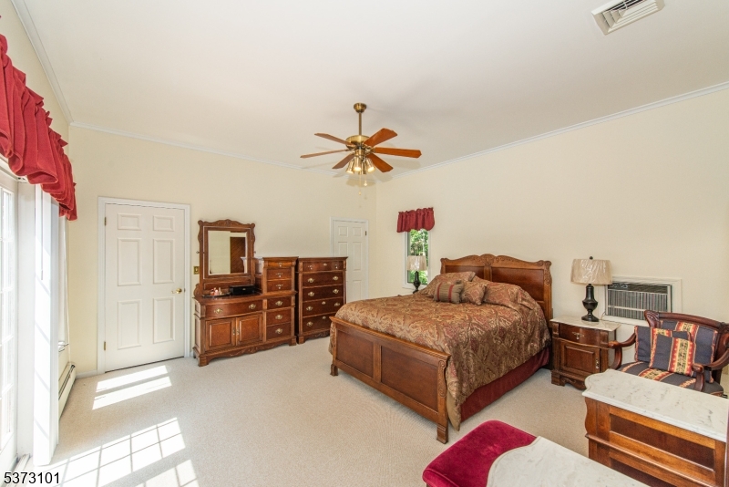 10 Campo Road Randolph, NJ 07869 - Photo 23 of 49 a bedroom with furniture and a chandelier