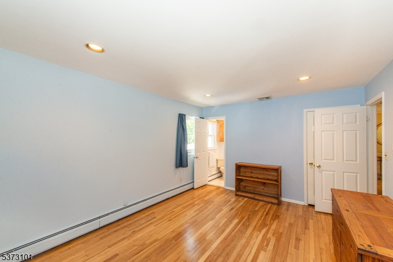 10 Campo Road Randolph, NJ 07869 - Photo 27 of 49 a view of an empty room with wooden floor and a window