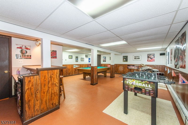 10 Campo Road Randolph, NJ 07869 - Photo 32 of 49 a living room with furniture pool and flat screen tv