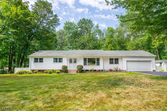 a living room with furniture a chandelier and a dining table