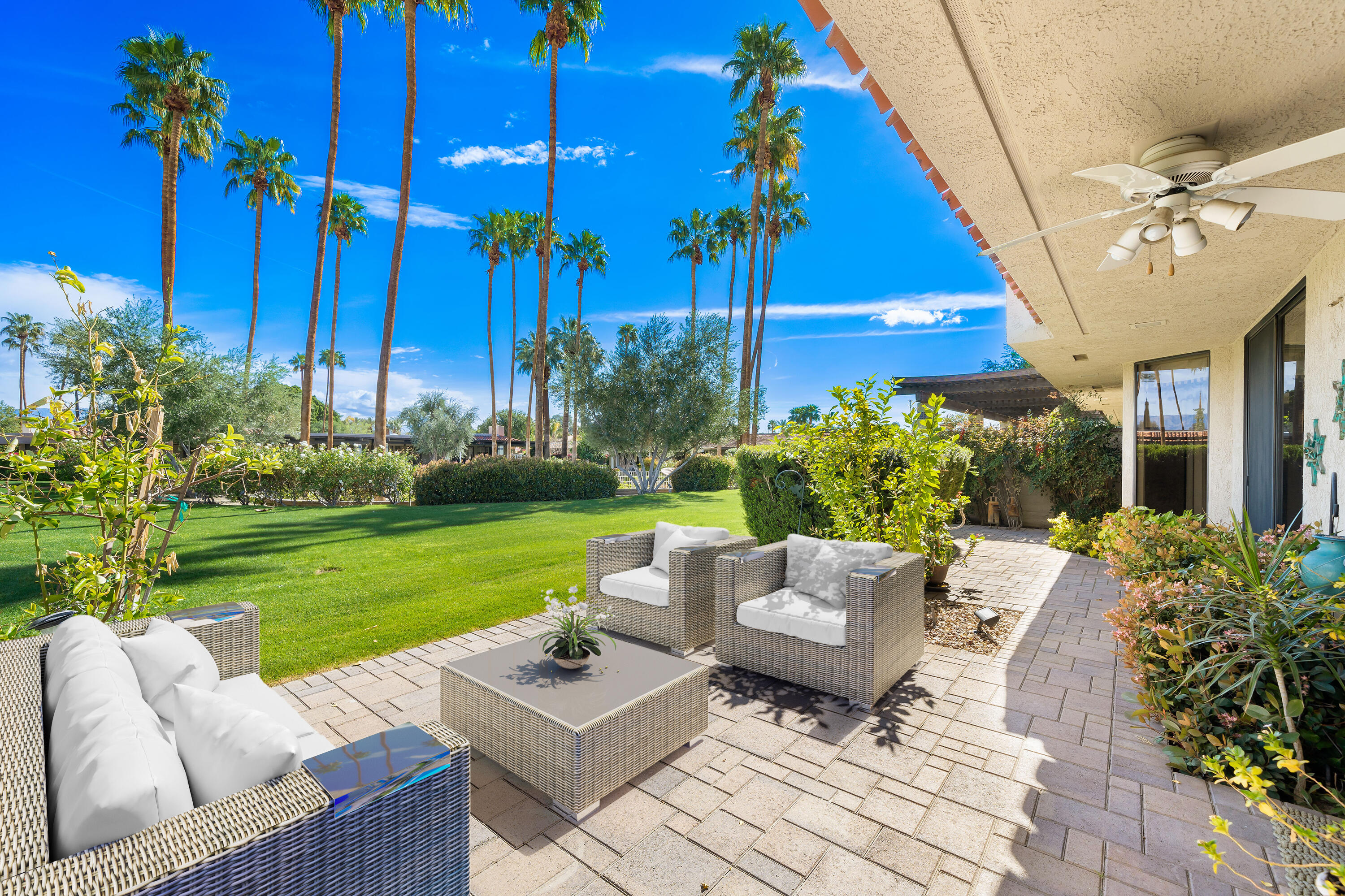 a view of an chairs and table in patio