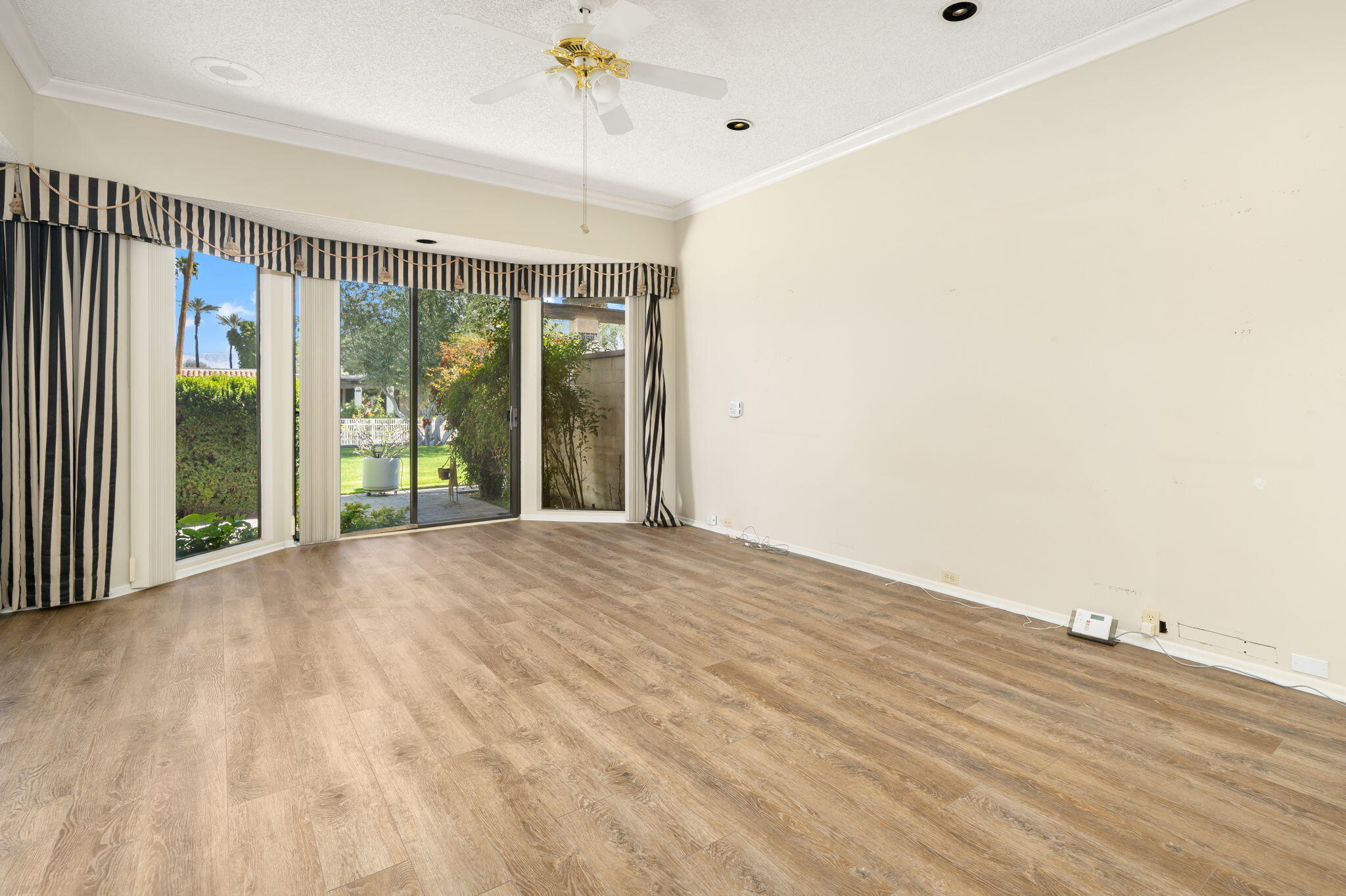 140 Columbia Drive Rancho Mirage, CA 92270 - Photo 15 of 31 a view of an empty room with glass door
