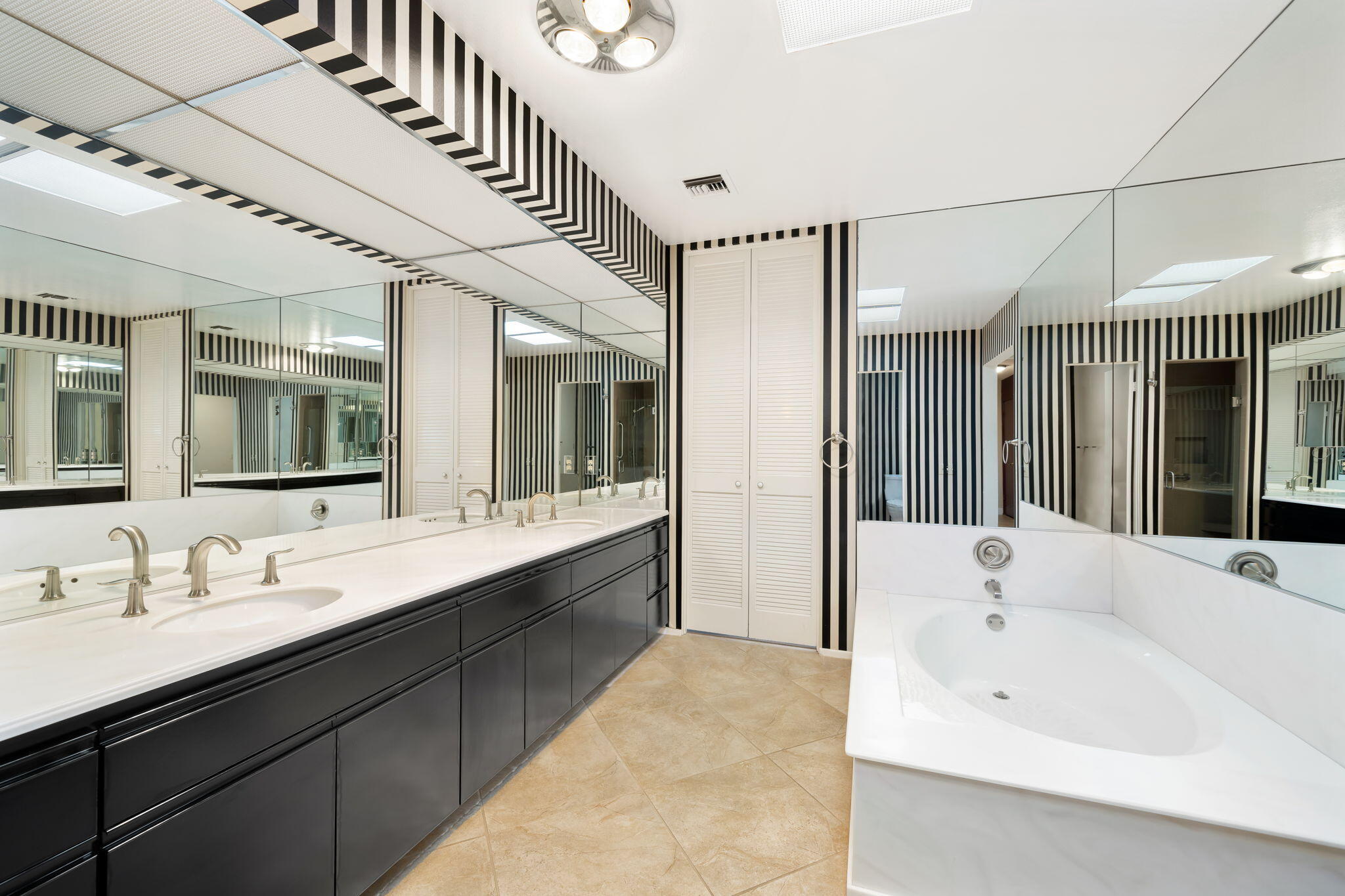 140 Columbia Drive Rancho Mirage, CA 92270 - Photo 17 of 31 a bathroom with a tub sink shower and mirror