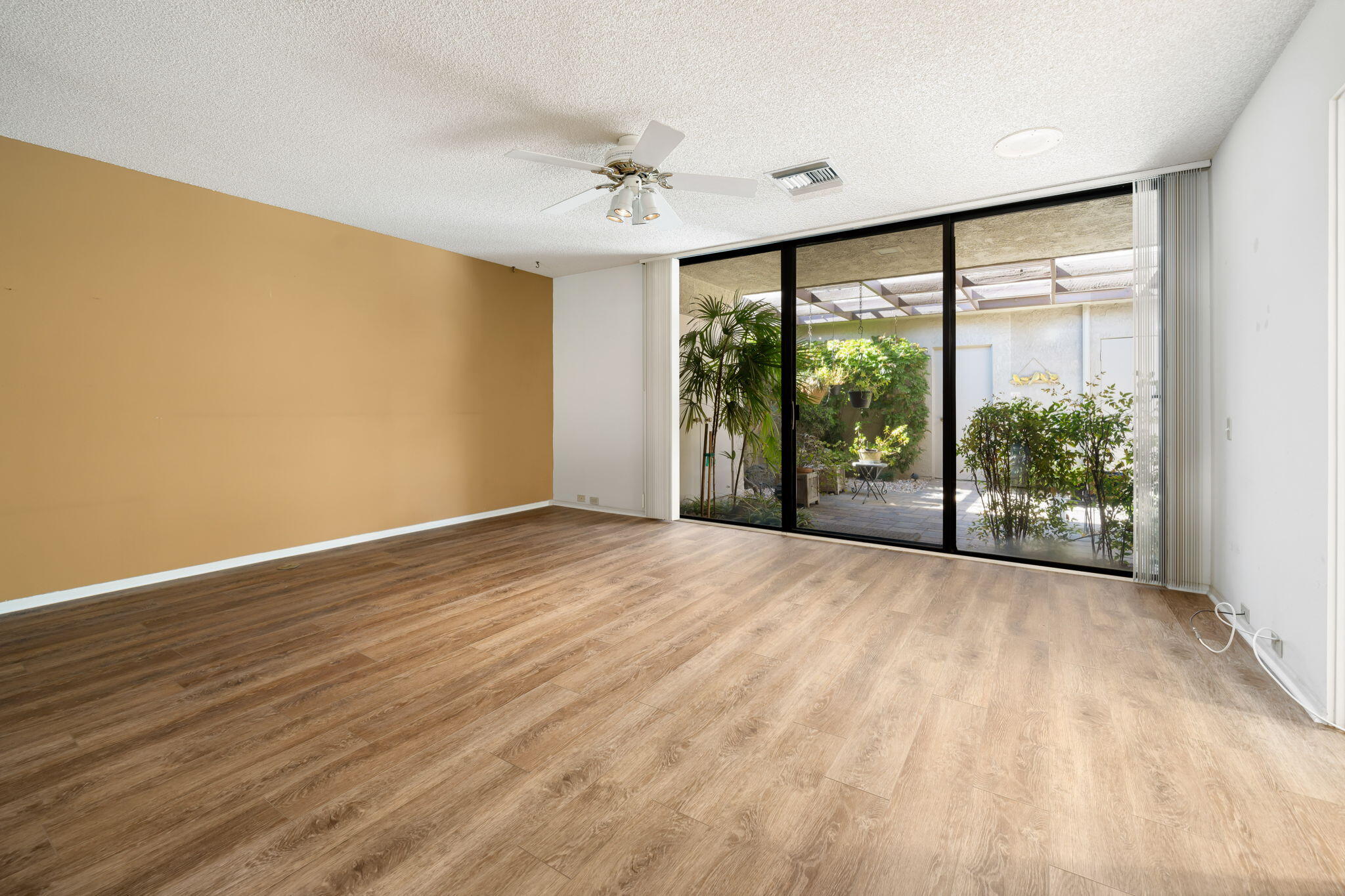 140 Columbia Drive Rancho Mirage, CA 92270 - Photo 20 of 31 a view of an empty room with wooden floor and a window