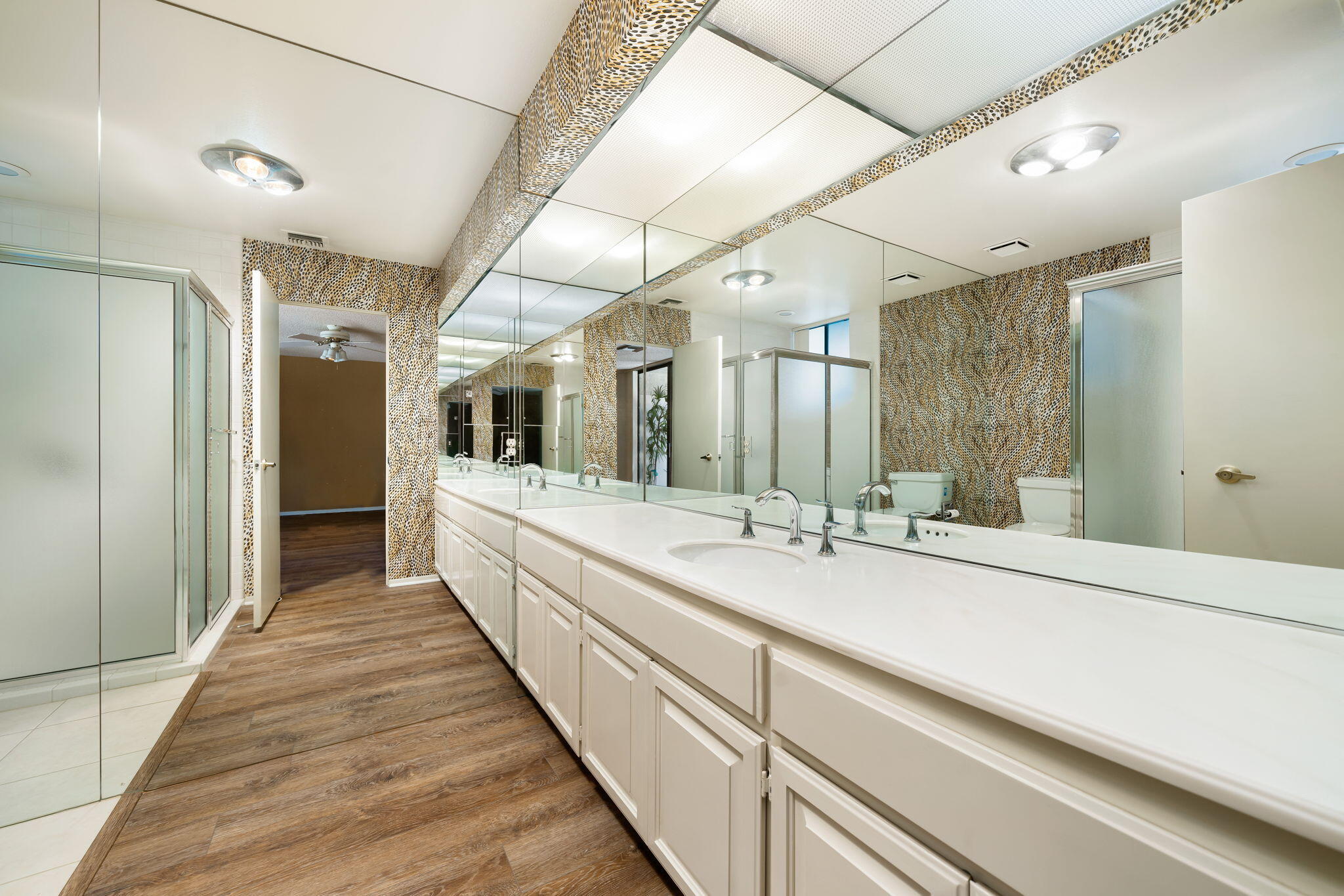 140 Columbia Drive Rancho Mirage, CA 92270 - Photo 21 of 31 a large white bathroom with a large mirror