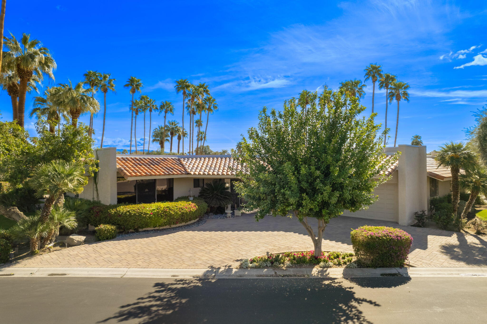 140 Columbia Drive Rancho Mirage, CA 92270 - Photo 31 of 31 a front view of a house with a yard and mountain view